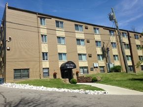 Cincinnati apartment for rent - a large building with a sign in front of it