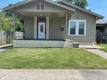 Baton Rouge house for rent - A house with a red door and a window is shown.