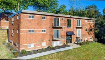 Cincinnati apartment for rent - a red brick apartment building with a sidewalk