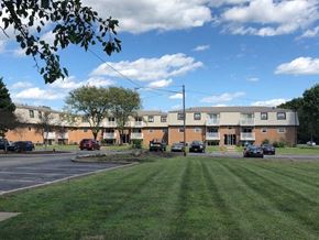 Carlisle apartment for rent - a green lawn in front of an apartment building