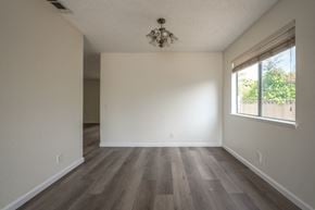 Rancho Cucamonga house for rent - A room with wooden floors and a chandelier.