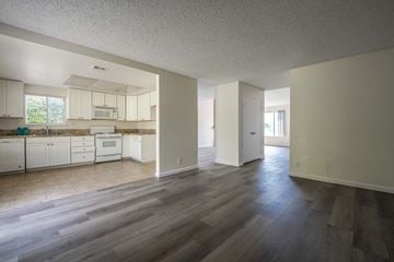 Rancho Cucamonga house for rent - A kitchen with white cabinets and a wooden floor.