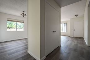 Rancho Cucamonga house for rent - A room with a white door and a window with a view of trees.