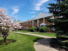 South Euclid apartment for rent - a brick building with a sidewalk and trees in front of it