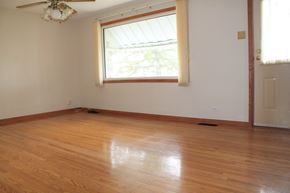 Brandon house for rent - an empty room with wooden floors and a window