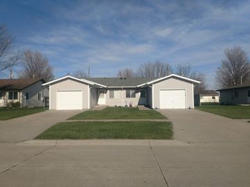 Kearney apartment for rent - a house with white garage doors and a driveway