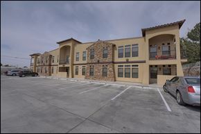El Paso apartment for rent - A large building with a parking lot in front of it.