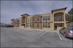 El Paso apartment for rent - a parking lot in front of a building with cars parked