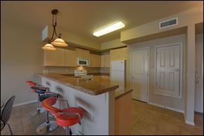 El Paso apartment for rent - A kitchen with a counter and bar stools.