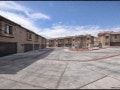 El Paso apartment for rent - A parking lot with a few cars and a building in the background.