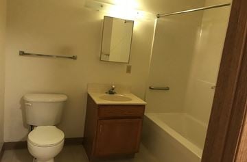Mount Pocono apartment for rent - A white toilet sits next to a sink in a small bathroom.