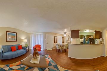 Dallas apartment for rent - A living room with a blue couch and a coffee table.