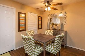 Dallas apartment for rent - A dining room with a wooden table and chairs with chevron patterned covers.