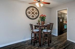 Fort Worth apartment for rent - A dining room with a wooden table and chairs.