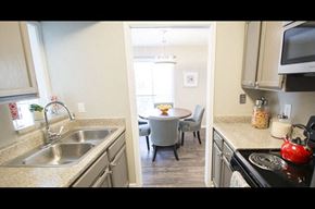 Houston apartment for rent - A kitchen with a table and chairs in the middle of the room.