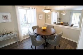 Houston apartment for rent - A dining room with a round table and grey chairs.