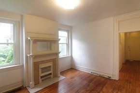 Pittsburgh apartment for rent - an empty living room with a fireplace and a window