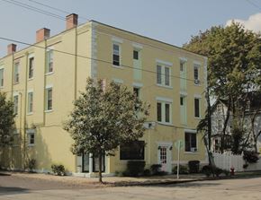 Pittsburgh apartment for rent - a large yellow house on the corner of a street