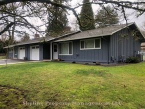 West Linn apartment for rent - a blue house with a lawn and trees