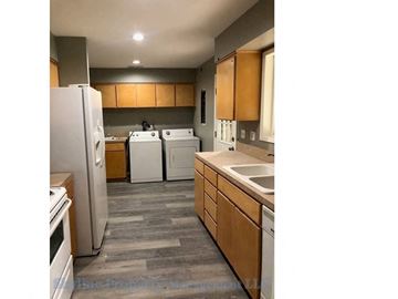 West Linn apartment for rent - a kitchen with white appliances and wooden cabinets