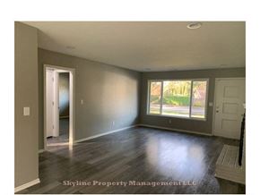 West Linn apartment for rent - an empty living room with hard wood floors and a window
