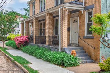 Pittsburgh apartment for rent - A brick house with a white door and windows.
