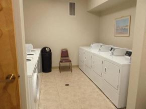 Portland apartment for rent - a laundry room with two washing machines and a chair