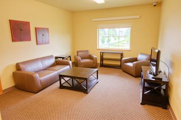 Vancouver apartment for rent - a living room with couches and chairs and a television