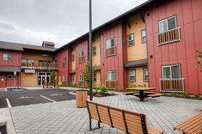 Vancouver apartment for rent - a courtyard with benches and a table outside of a building