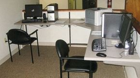 Portland apartment for rent - a desk with two chairs and a computer on it