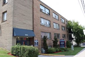 Toronto apartment for rent - a brick building with a sign in front of it