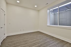 Philadelphia apartment for rent - an empty living room with a large window and wood flooring