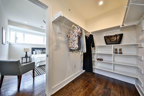 Philadelphia apartment for rent - a walk in closet with a door open to a bedroom with a bed and shelves