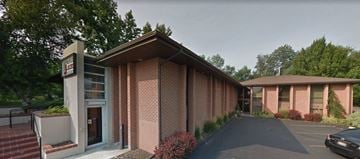 Boise apartment for rent - a brick building with a car parked in front of it