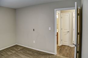 Shelbyville apartment for rent - an empty bedroom with a door open to a hallway