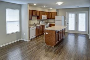 Shelbyville apartment for rent - a kitchen with wooden floors and a white refrigerator