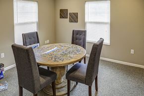 Shelbyville apartment for rent - a dining room table with four chairs and two windows