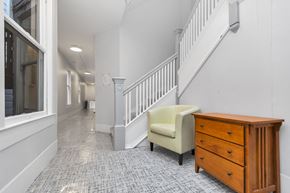San Francisco apartment for rent - A hallway with a chair and a dresser.