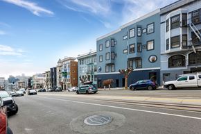 San Francisco apartment for rent - A street view with cars, buildings, and a tree.
