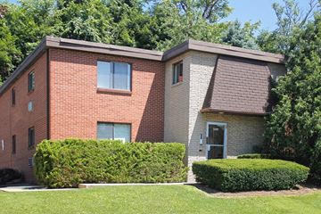 Pittsburgh apartment for rent - A red brick house with a grey roof and a green lawn in front.