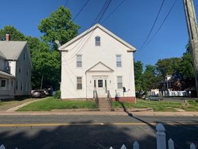Manchester apartment for rent - a white house on the corner of a street