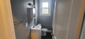 Manchester apartment for rent - a bathroom with a toilet and a sink and a window