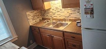 Manchester apartment for rent - a kitchen with a sink and a refrigerator
