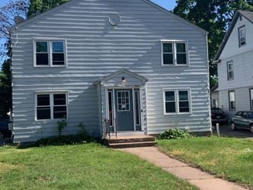 Manchester apartment for rent - a white house with a blue door and a sidewalk