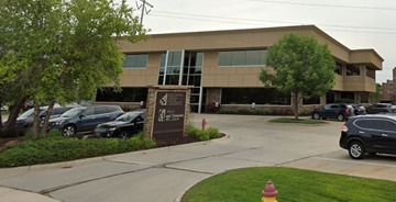 Elkhorn apartment for rent - A building with a sign that says "The Woodlands" in front of it.