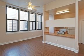 Winona apartment for rent - A room with a ceiling fan and large windows.
