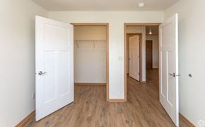 River Falls apartment for rent - A room with a white door and a wooden floor.