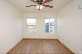 River Falls apartment for rent - A room with a ceiling fan and two windows.