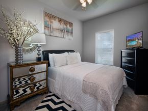 Canton apartment for rent - a bedroom with a bed and a dresser and a window