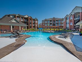 Canton apartment for rent - a swimming pool with a fountain in front of an apartment building